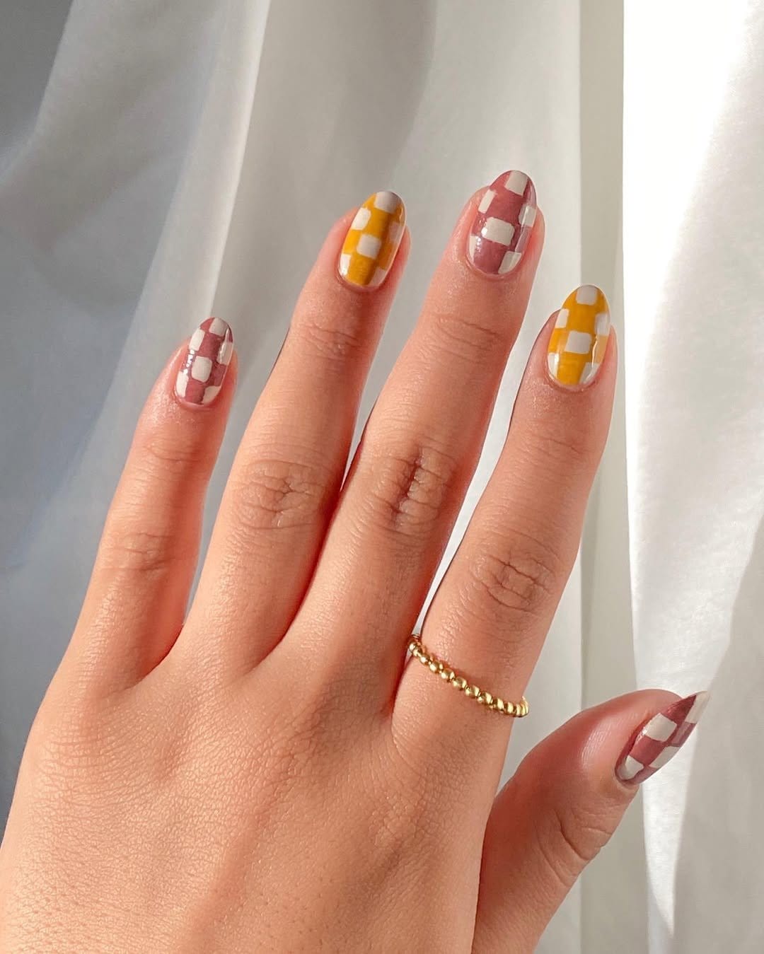 Yellow and white checkerboard nails