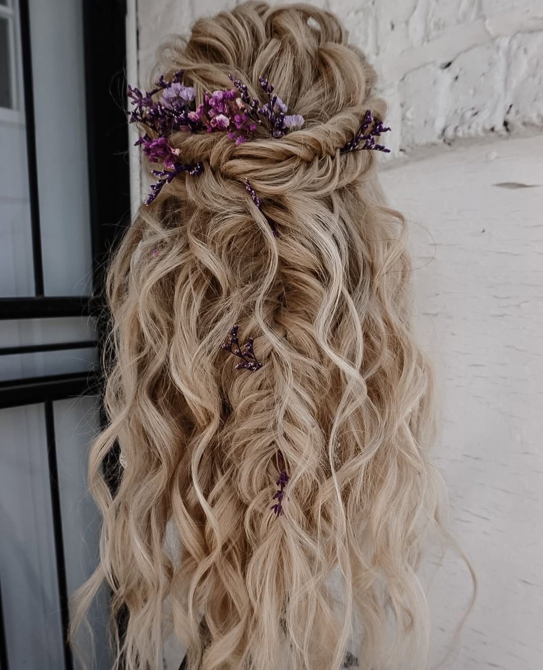 Bohemian wavy hairstyle with floral accents