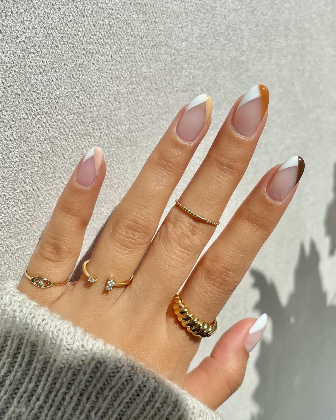 Chevron-patterned French tip nails in zigzag design