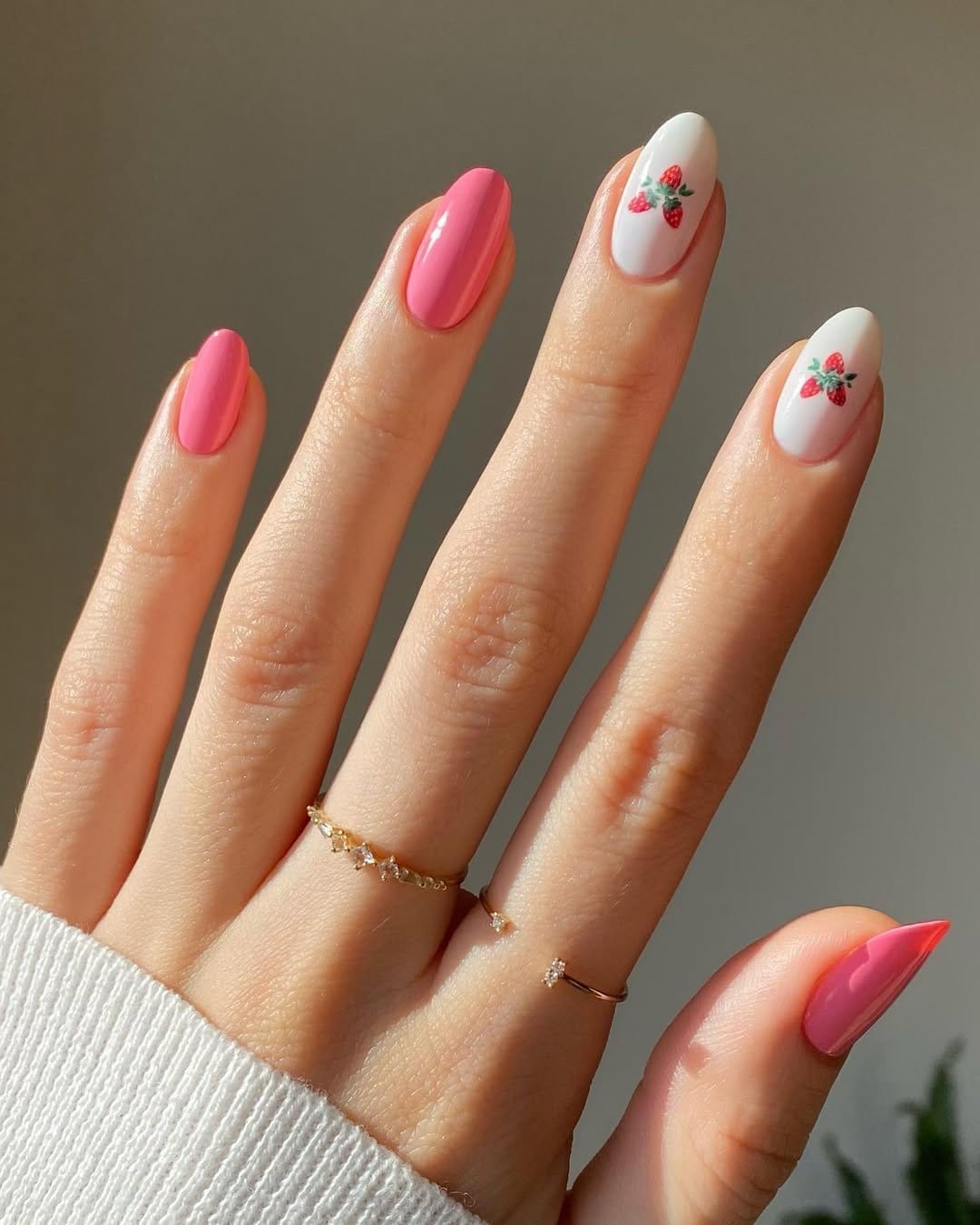 Strawberry nail art on a light pink base