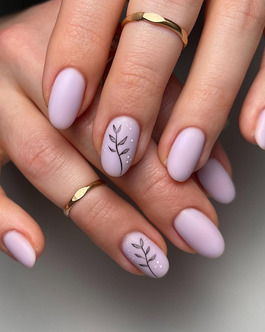 Minimalist leafy nail art on nude background
