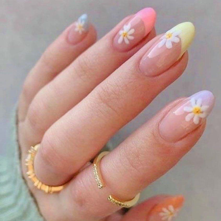 Daisy chain nail art on a pale yellow background