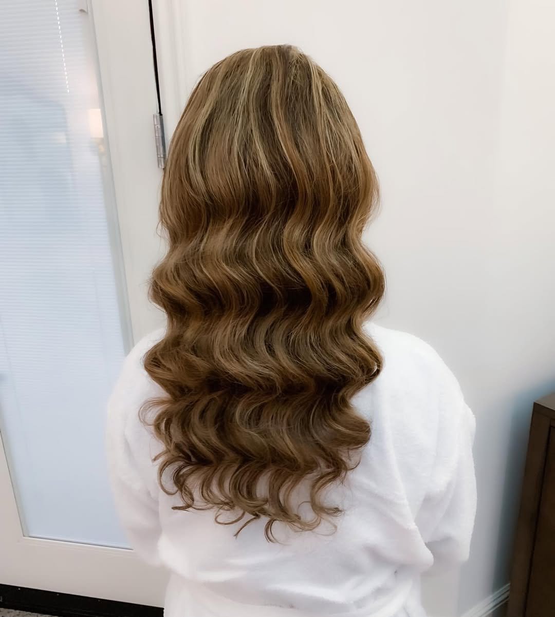 Sleek wavy hairstyle with center part