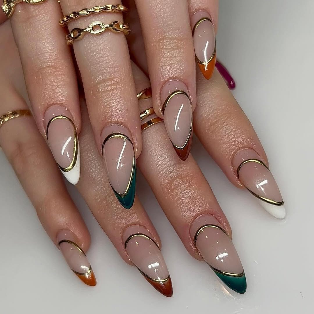 Jewel-toned French tip nails in rich colors