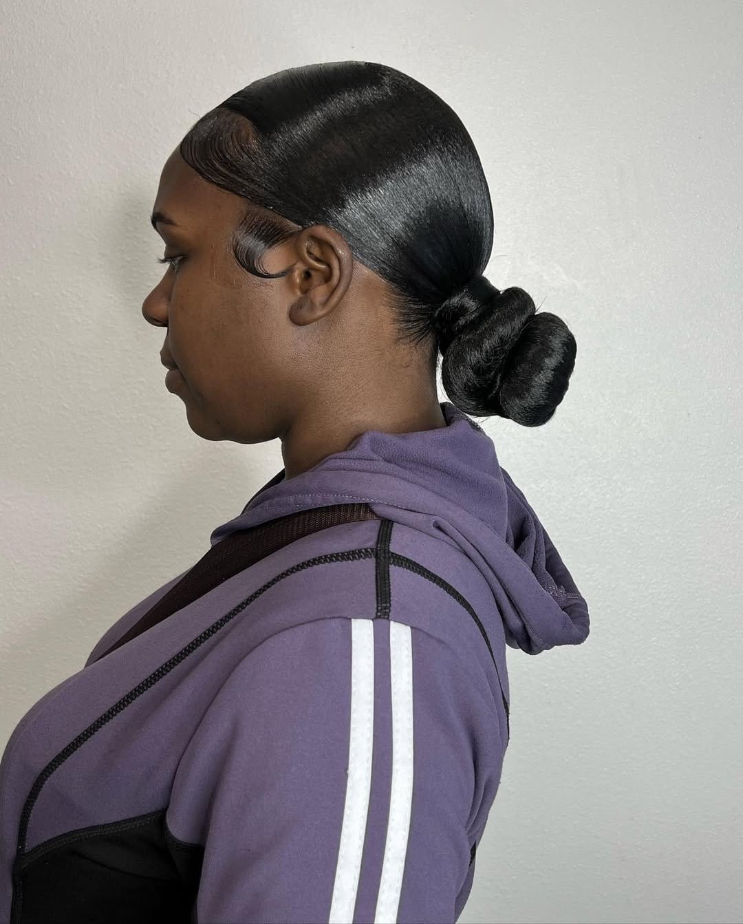 Sleek bun with precise middle part