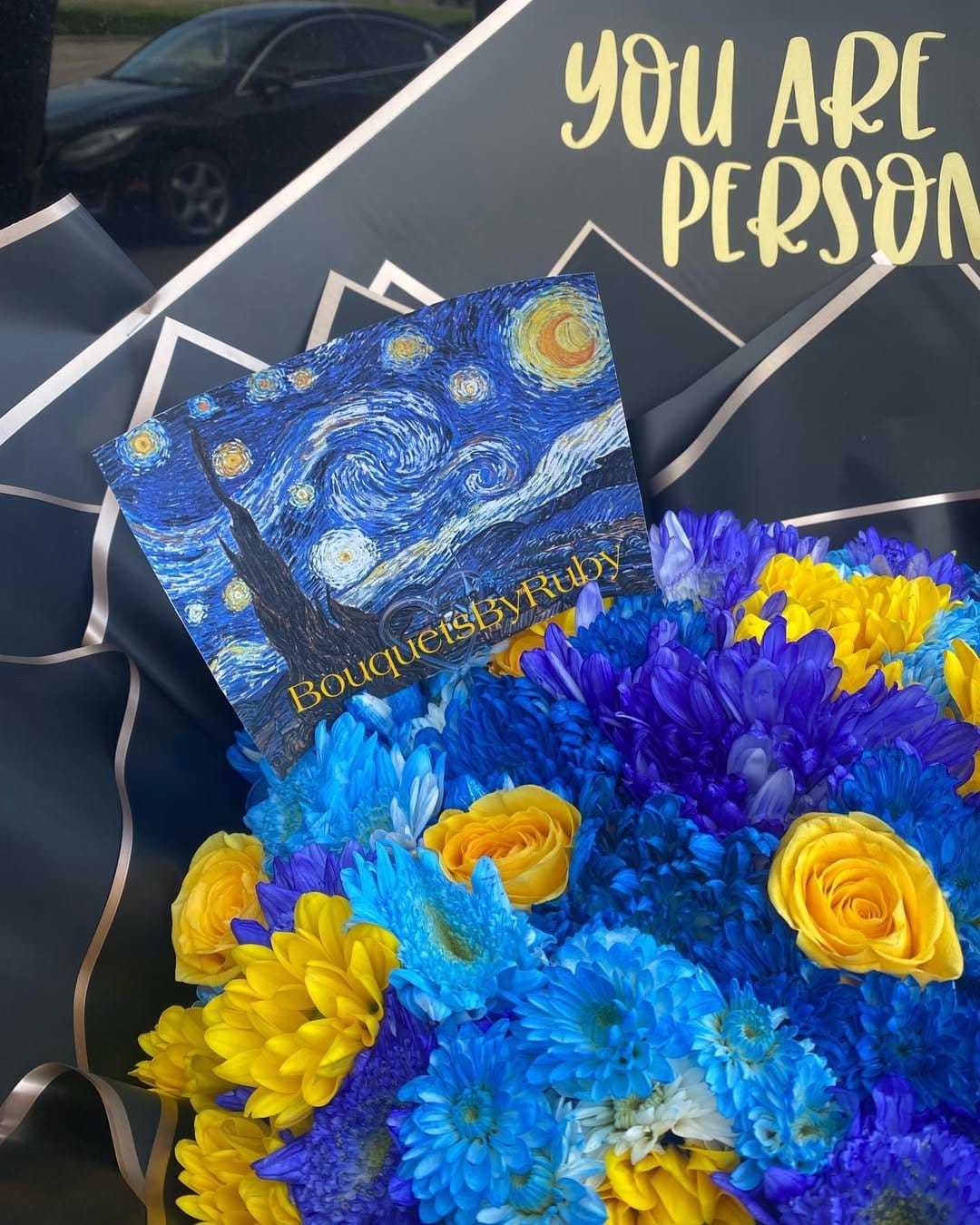 Starry night-themed nail art with floral accents