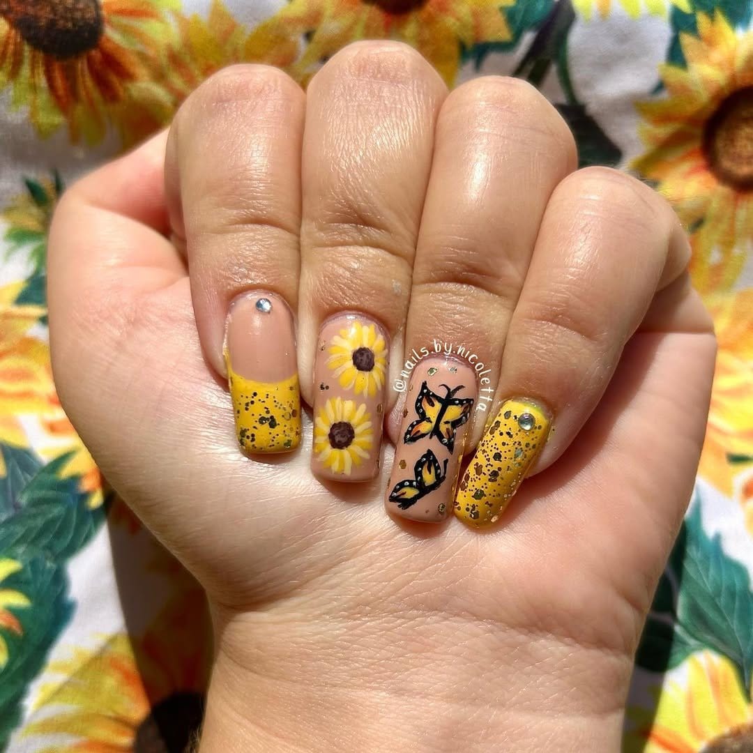 Nail art with multiple sunflowers and leaves