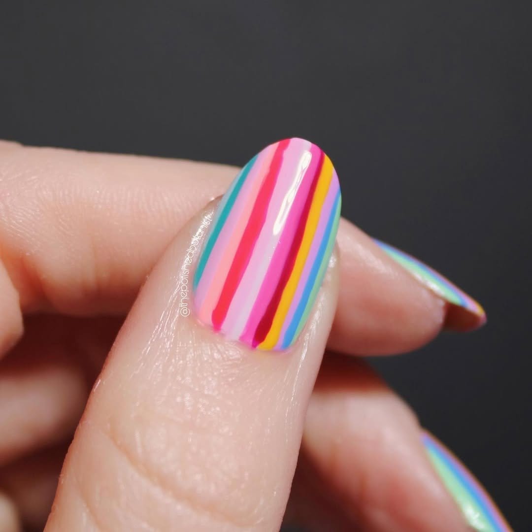 Holographic striped French tip nails with rainbow effect