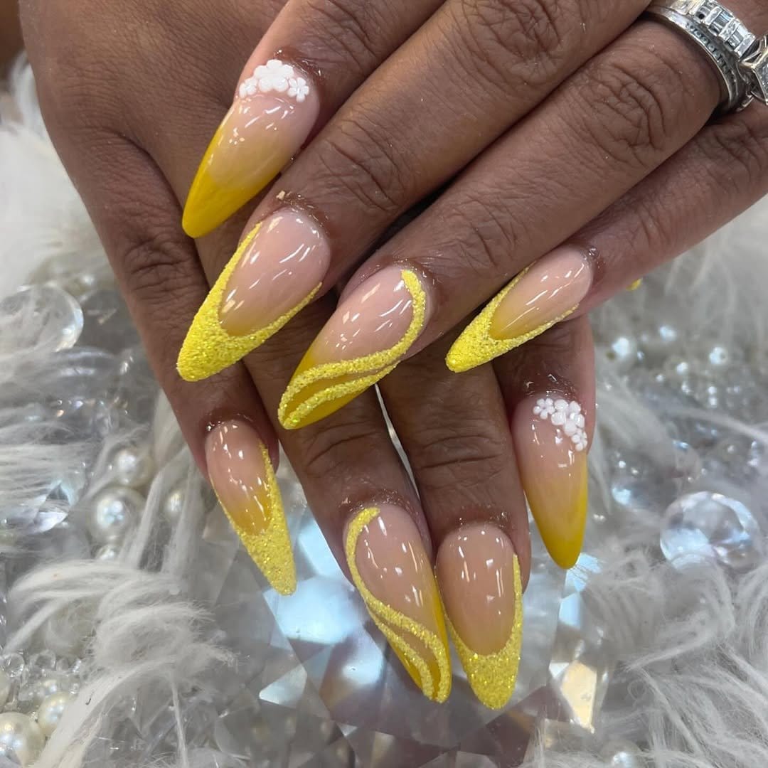 Yellow nails with gold glitter tips