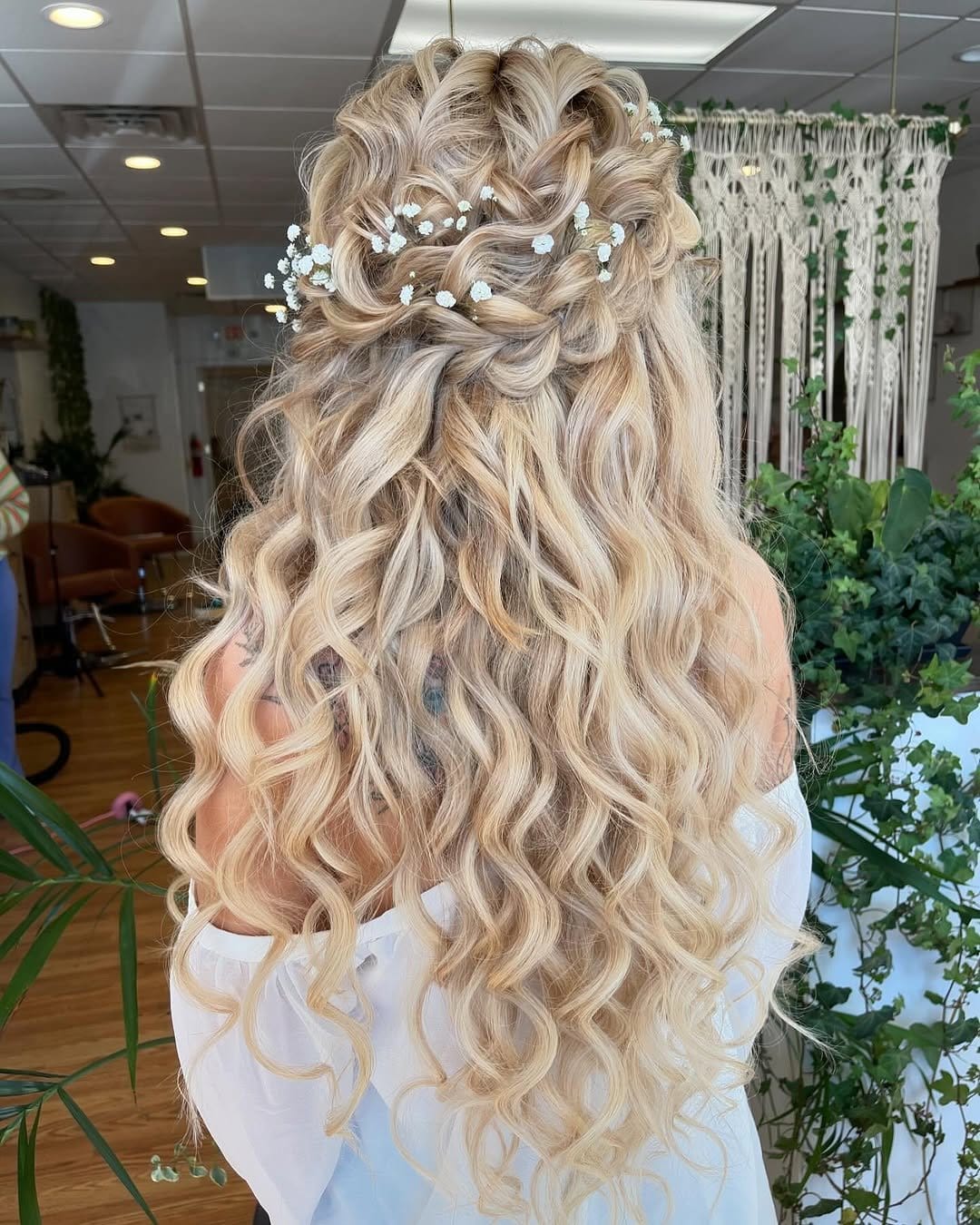 Charming half-up braided crown with floral accents