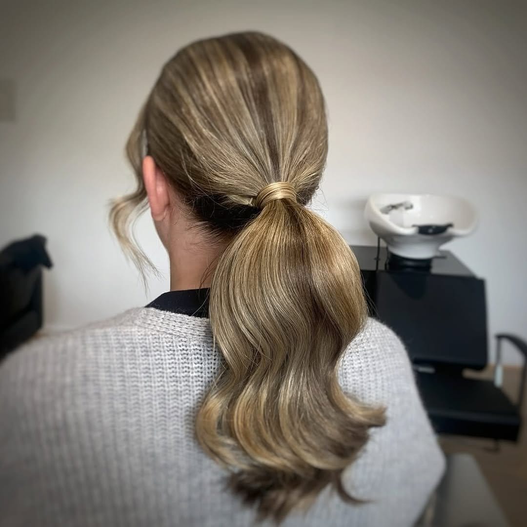 Polished low ponytail with sleek finish