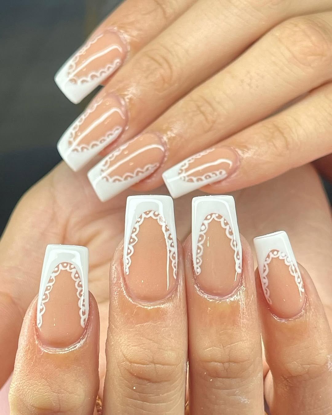 Lace-detailed French tip nails in intricate patterns