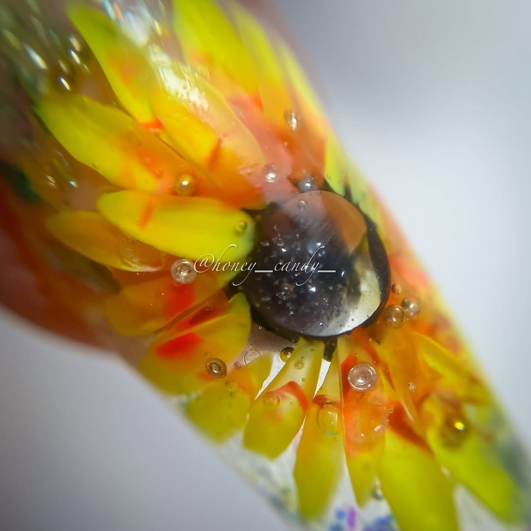 Rainbow-colored sunflower nail art