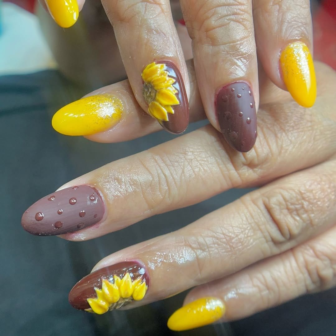 Sunflower nail art with bright yellow petals
