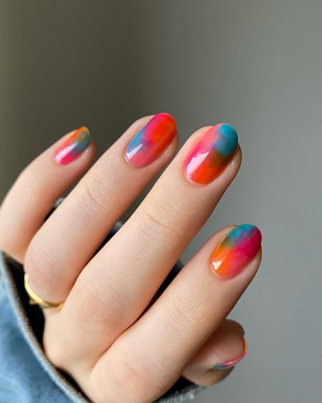 Pastel watercolor effect nail art with glossy finish
