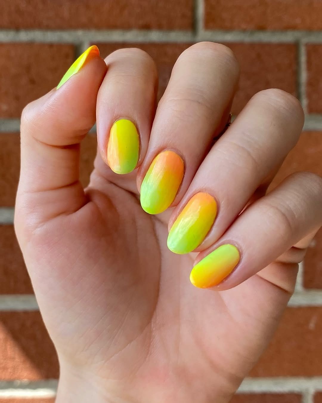 Bright yellow neon nails in disco light