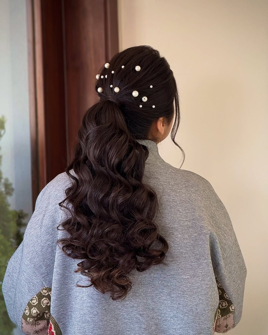 Textured ponytail adorned with hair accessories