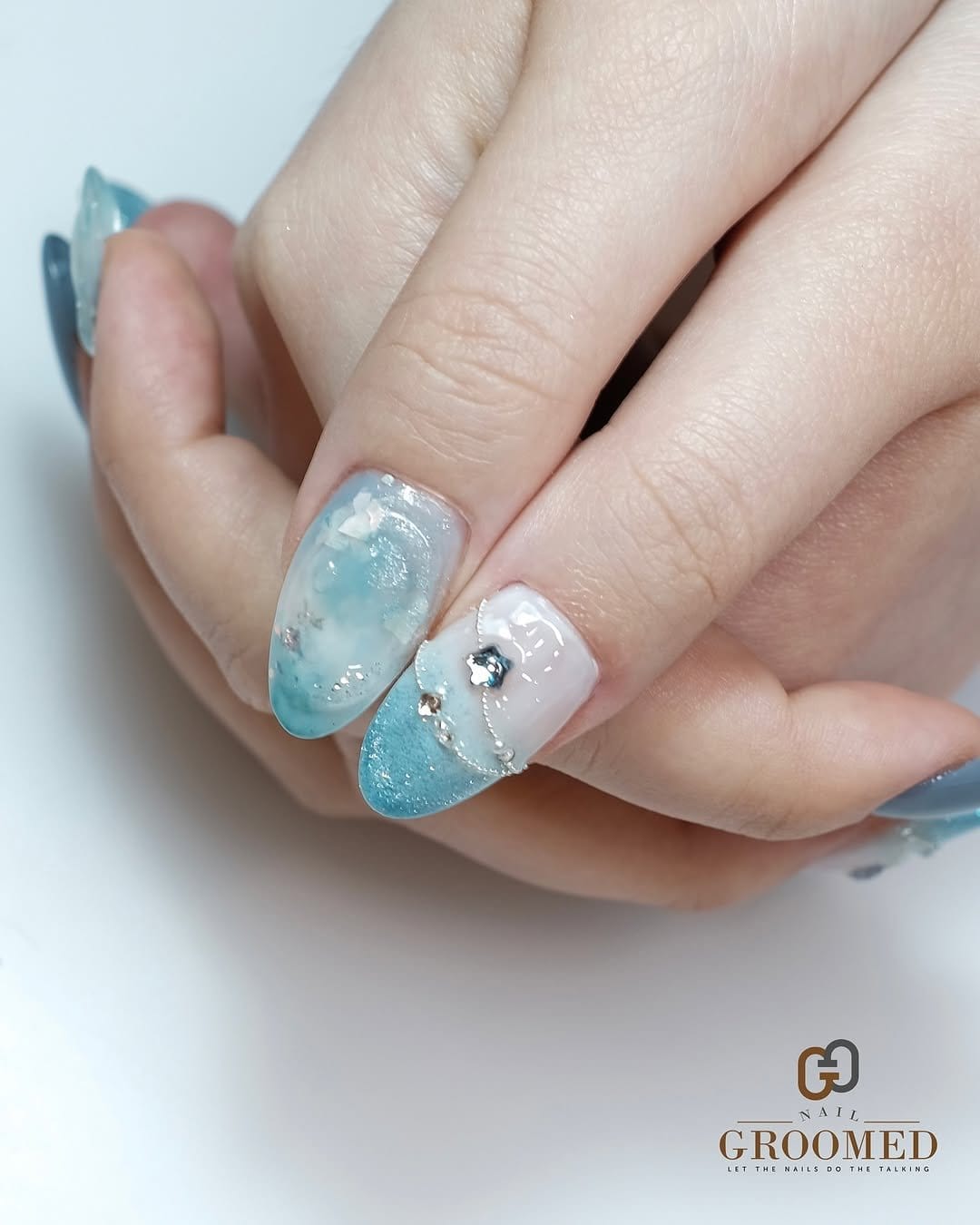 Icy blue pastel nails with snowflake designs