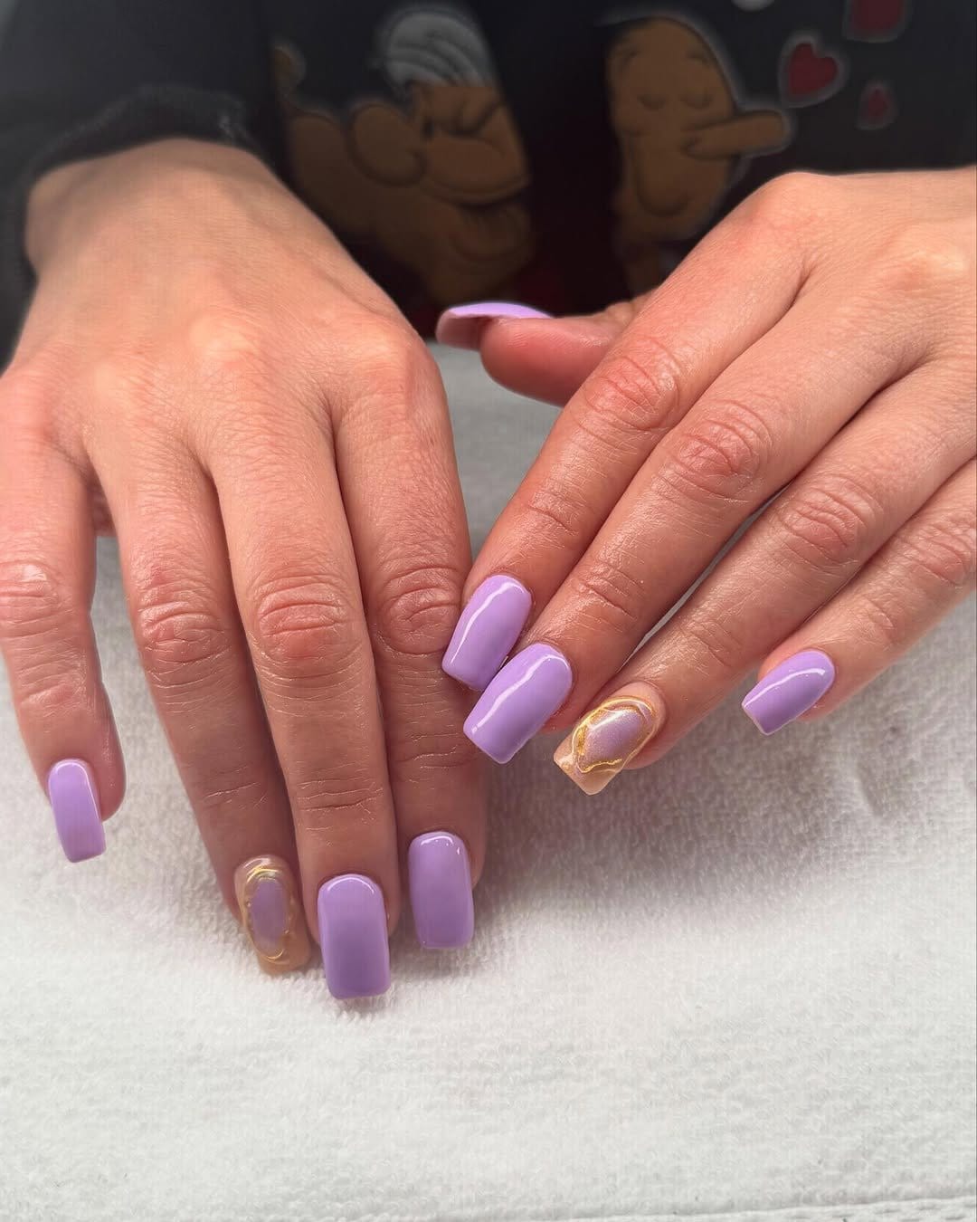 Soft lavender nail polish with gold accents