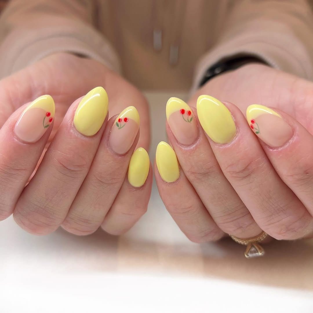 Bright yellow nails with white polka dots