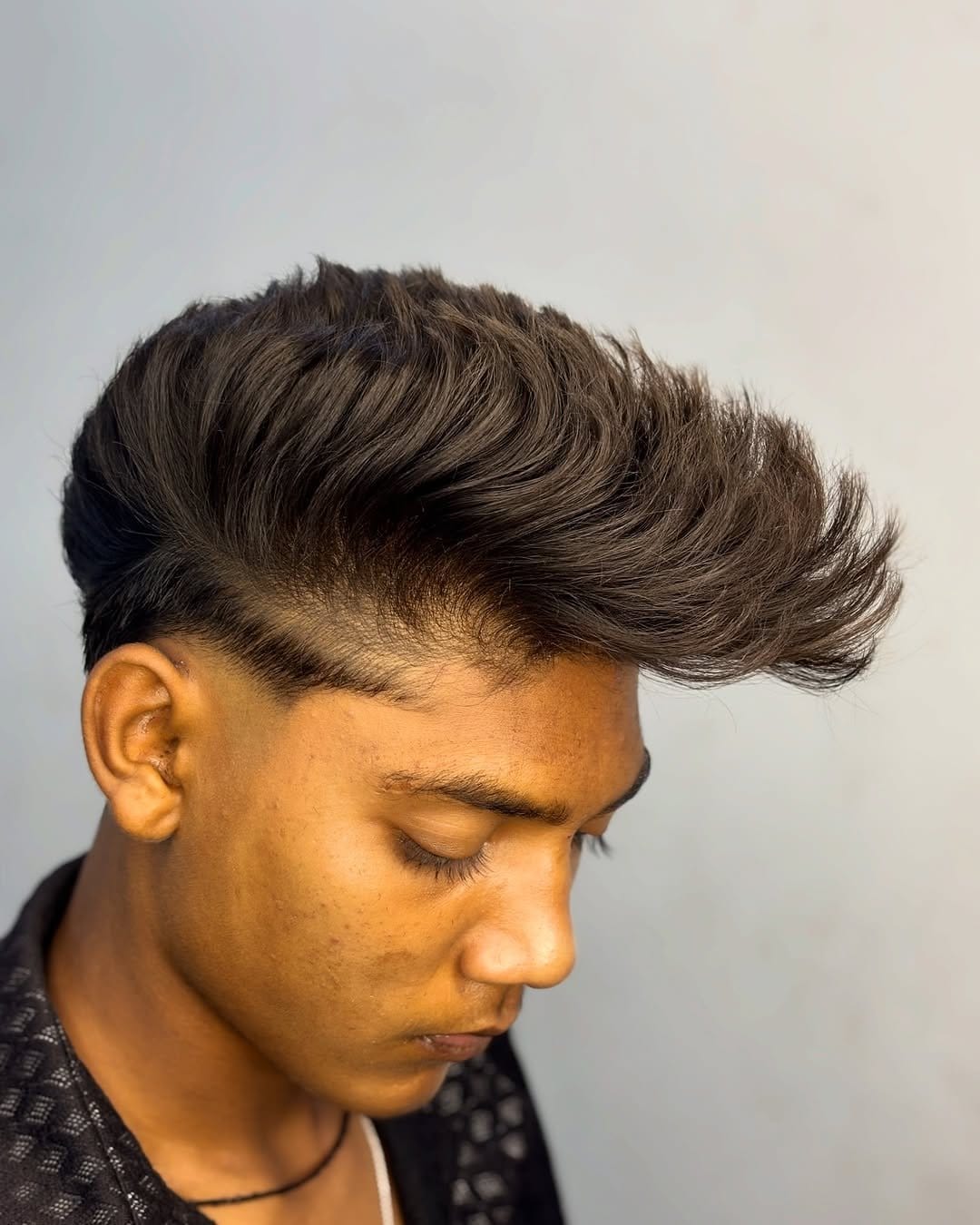 Pompadour hairstyle with bold makeup