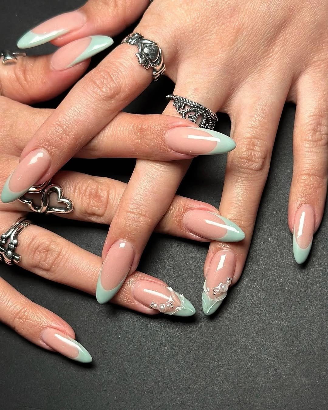 Mint green French tip nail design with glossy finish