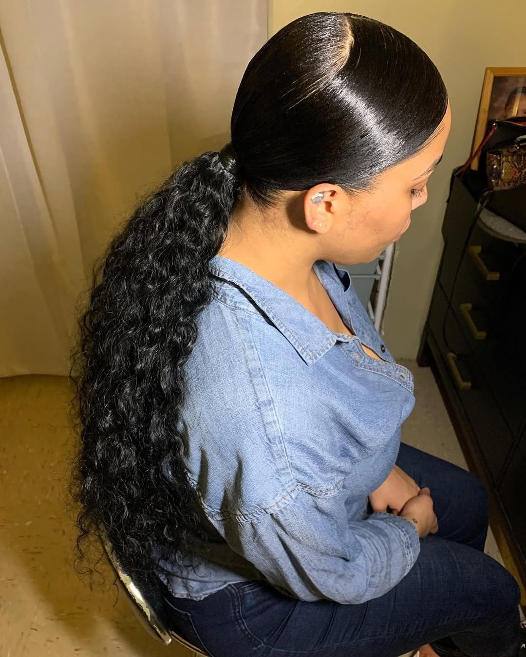 Sleek low ponytail with middle part