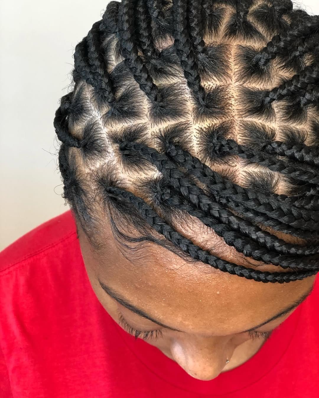 Short dreadlocks pulled into a low ponytail