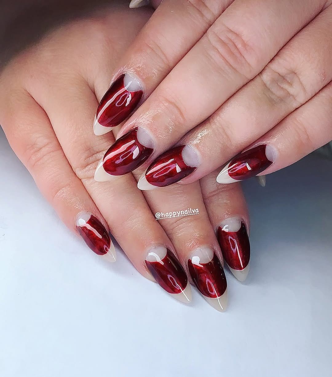 Red half-moon nail design with white base