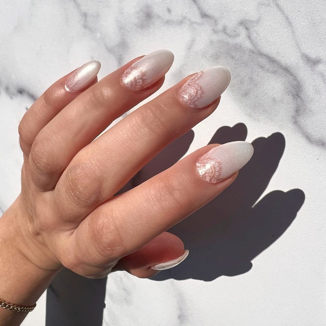 Lace-patterned nails in soft colors