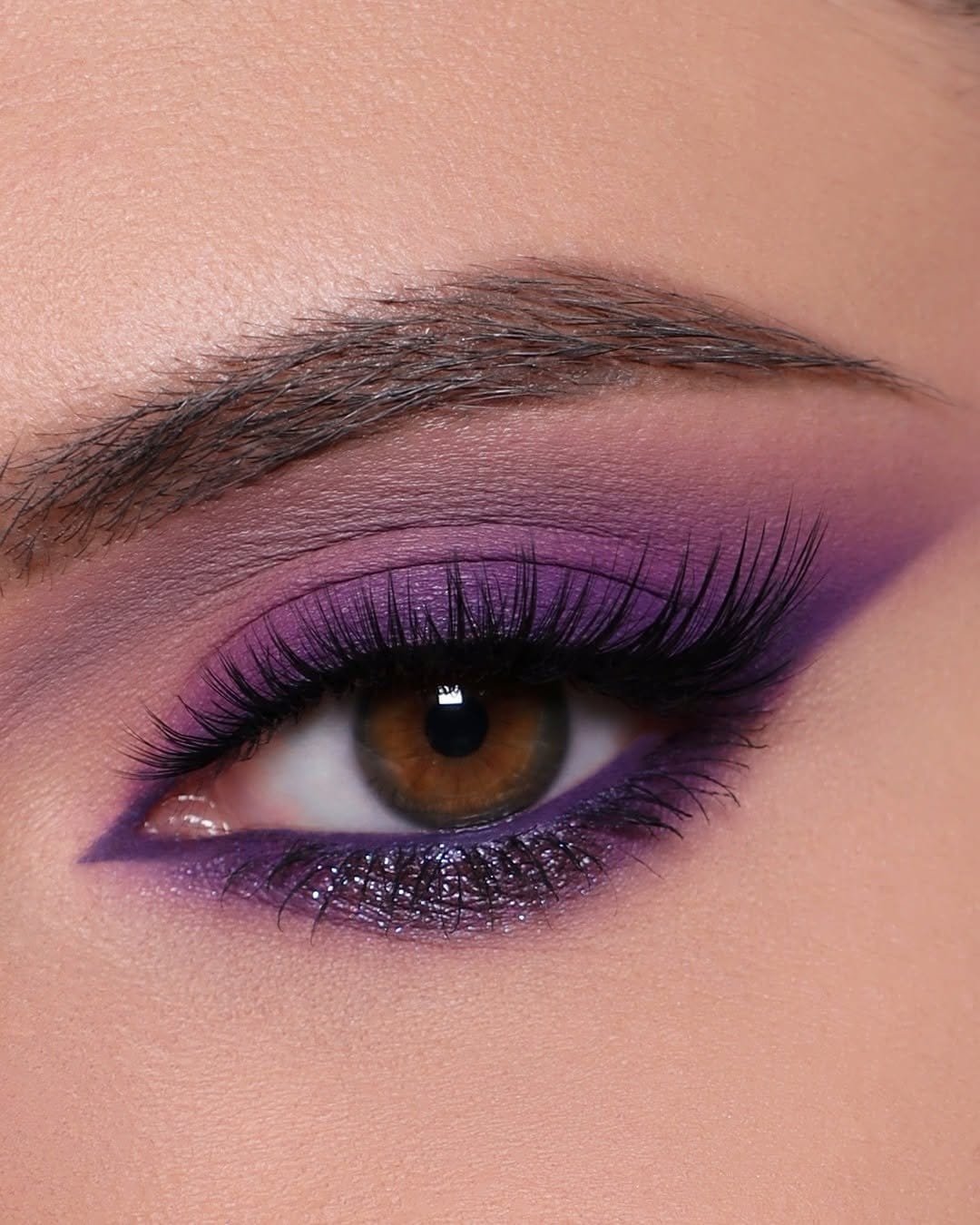 Vibrant purple smokey eye makeup with dramatic eyeliner