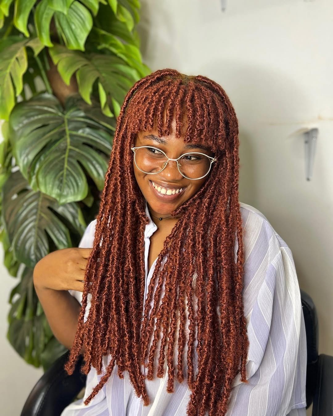 Short dreadlock fringe framing the face