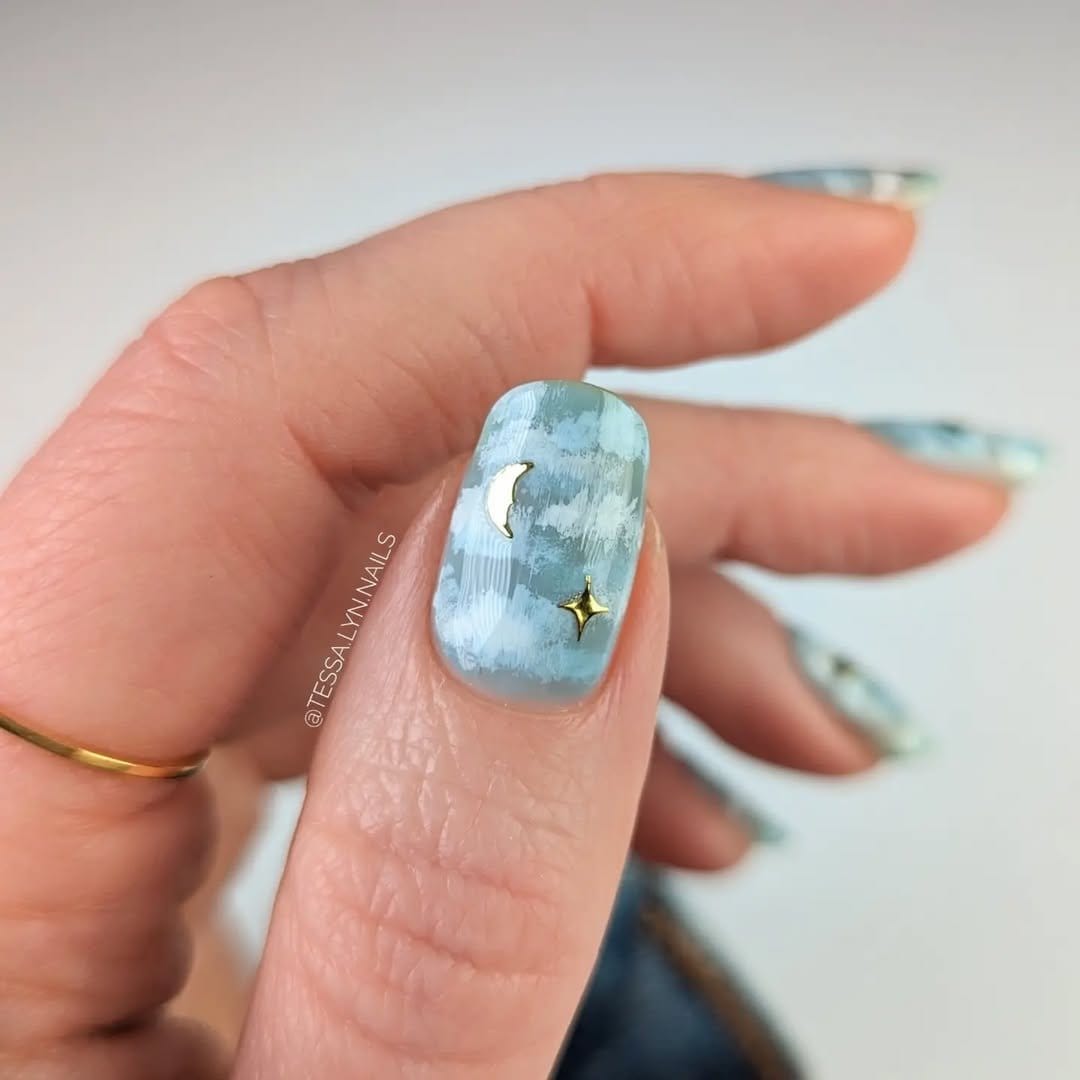 Cloud nail art on light blue nails