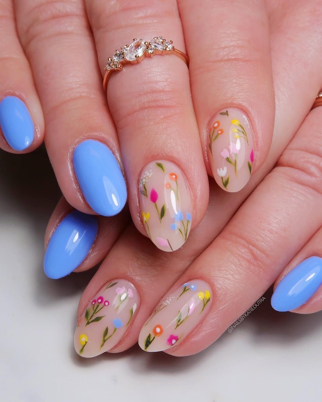 Artistic floral nail art on pastel background