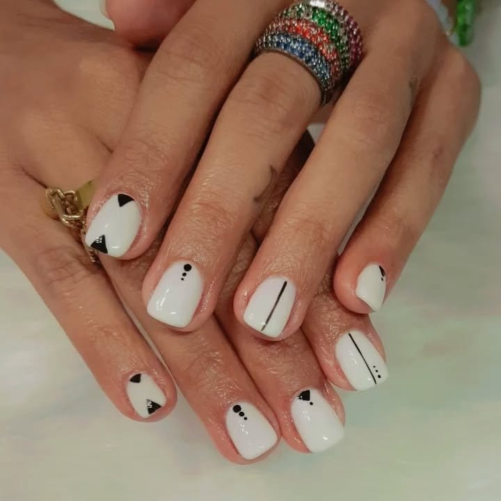 White nails with geometric patterns