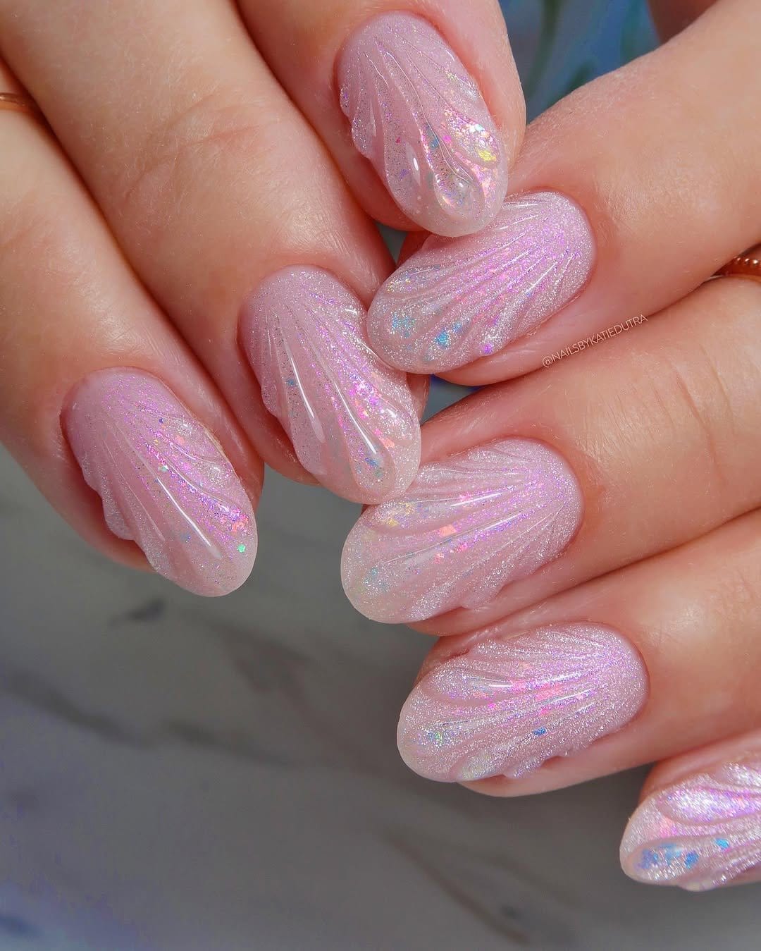 Pale coral pastel nails with seashell accents