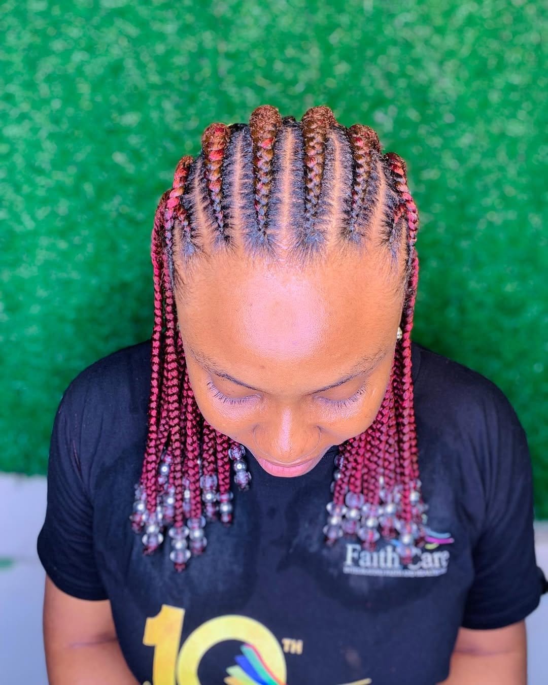 Vibrant beaded short dreadlocks in natural setting