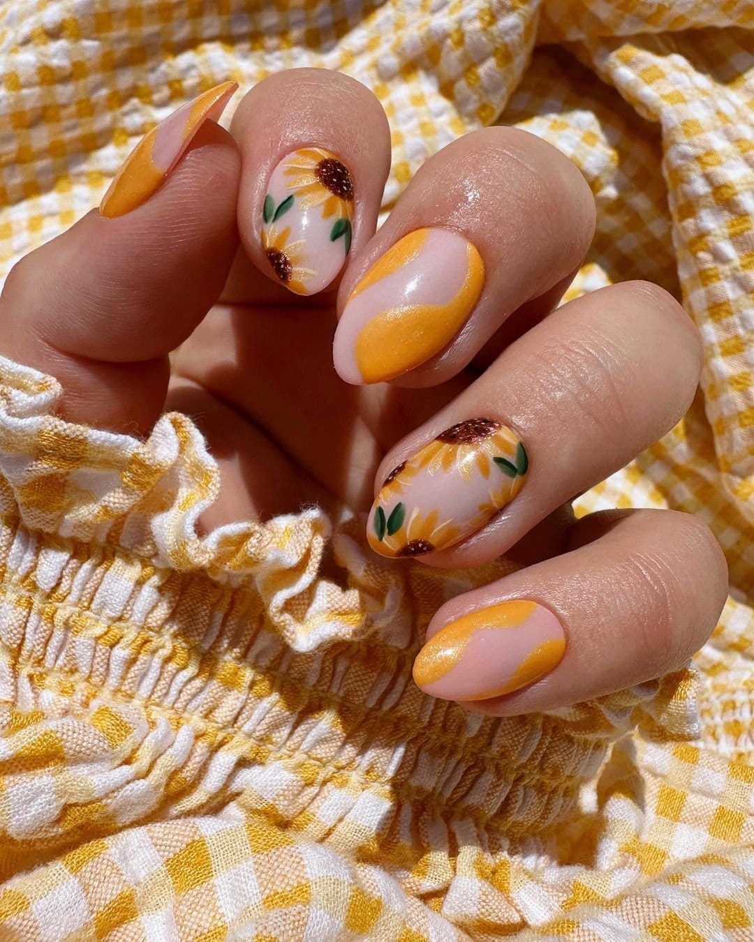 Marigold flower nail art on an orange base
