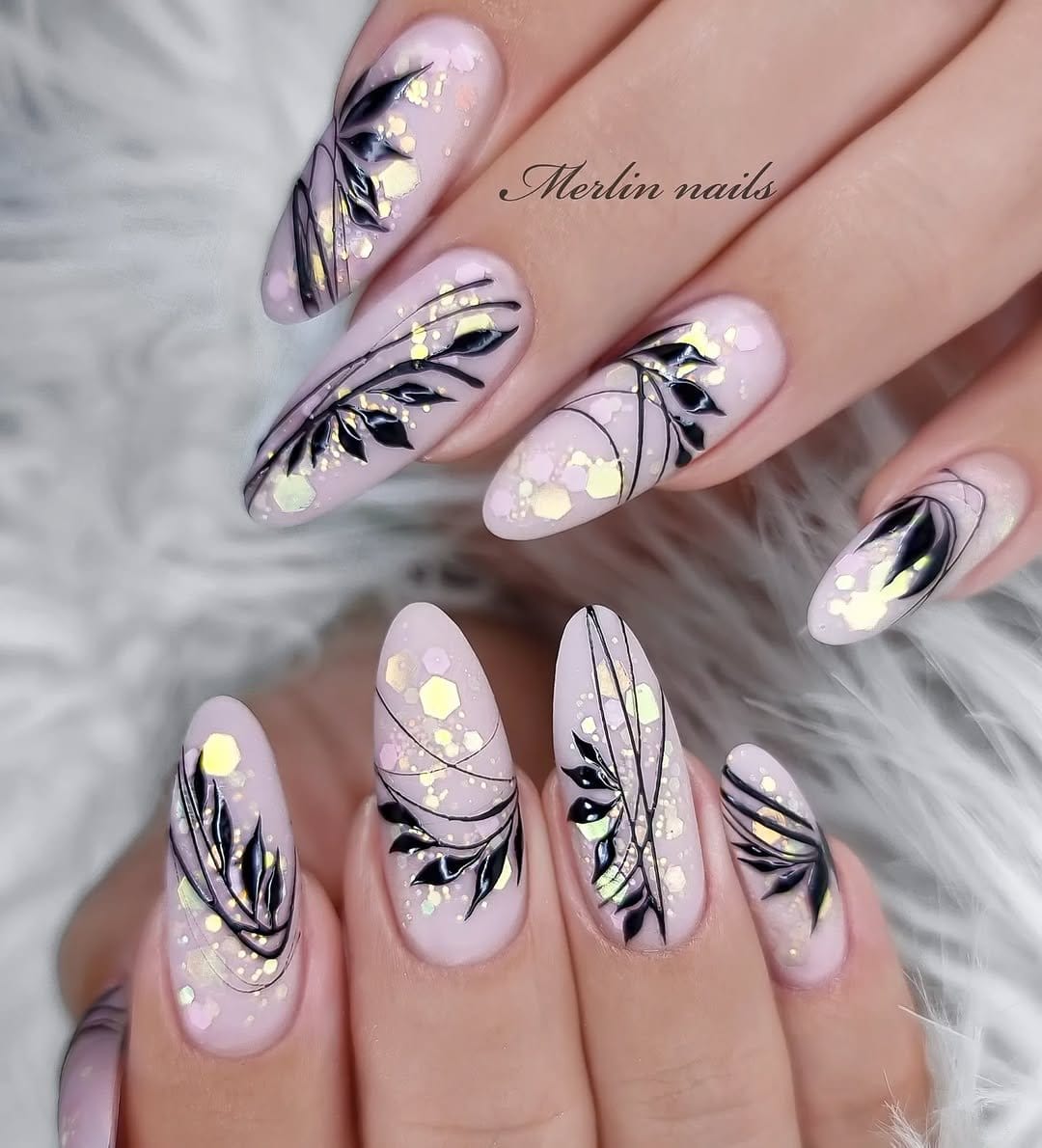 Black and white floral nail art on a neutral base