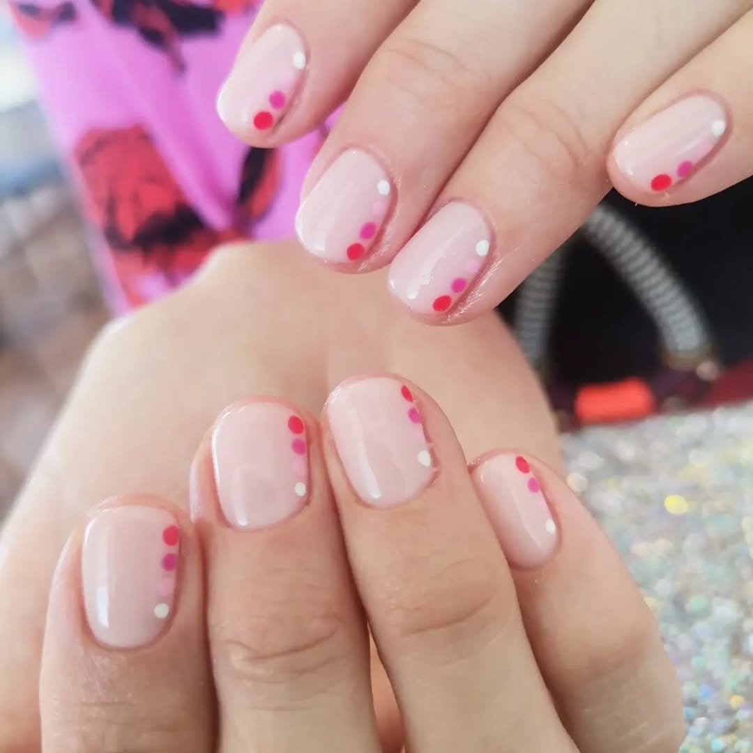 Small polka dots on light pink nails