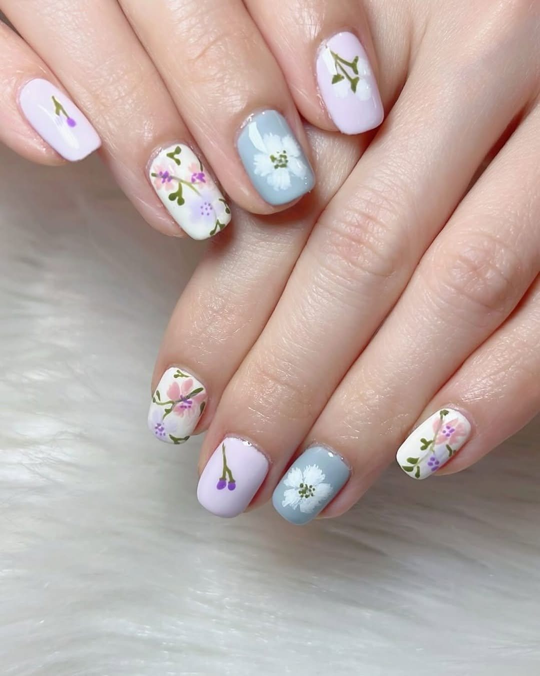 Delicate floral nail art on a white background