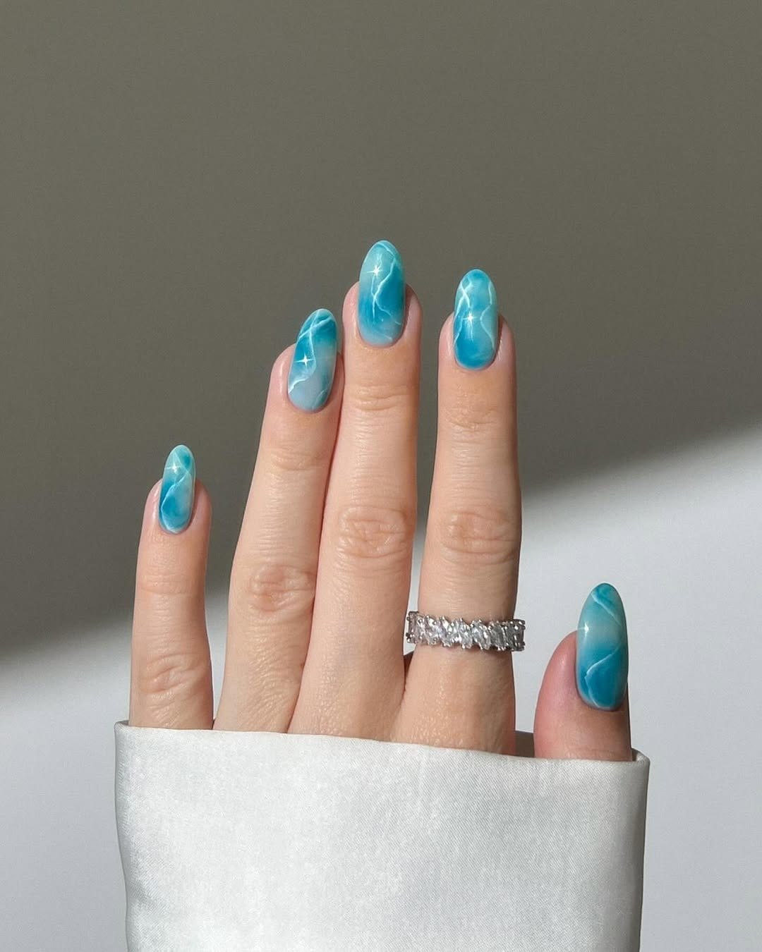 White floral nails with gold accents