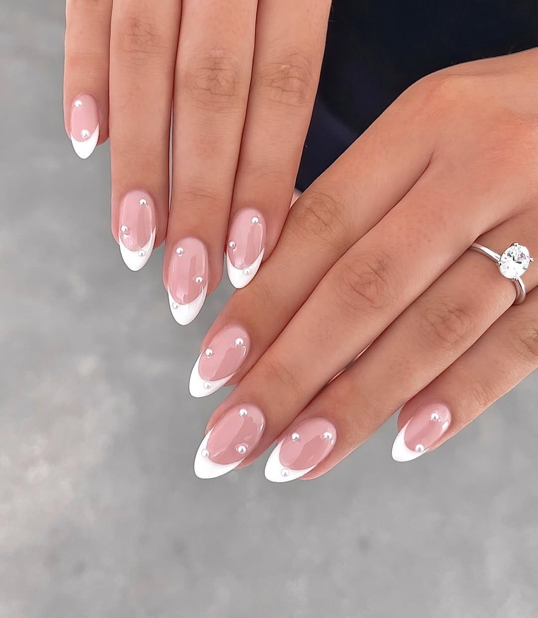 White nails with pearl and glitter embellishments