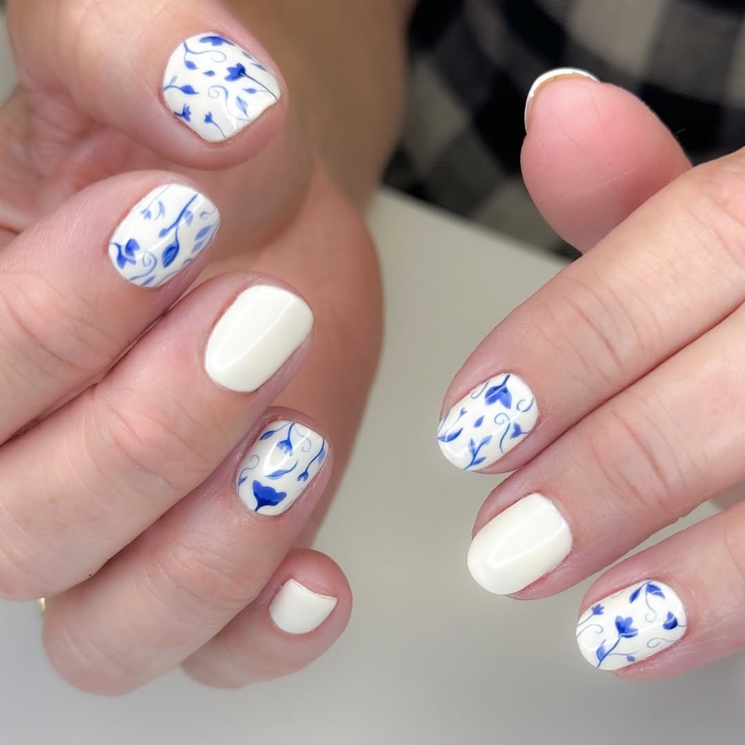 White nails with delicate floral patterns