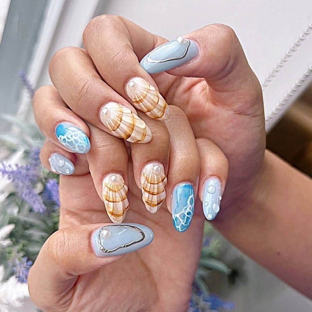 Pastel blue-green nails with shell accents