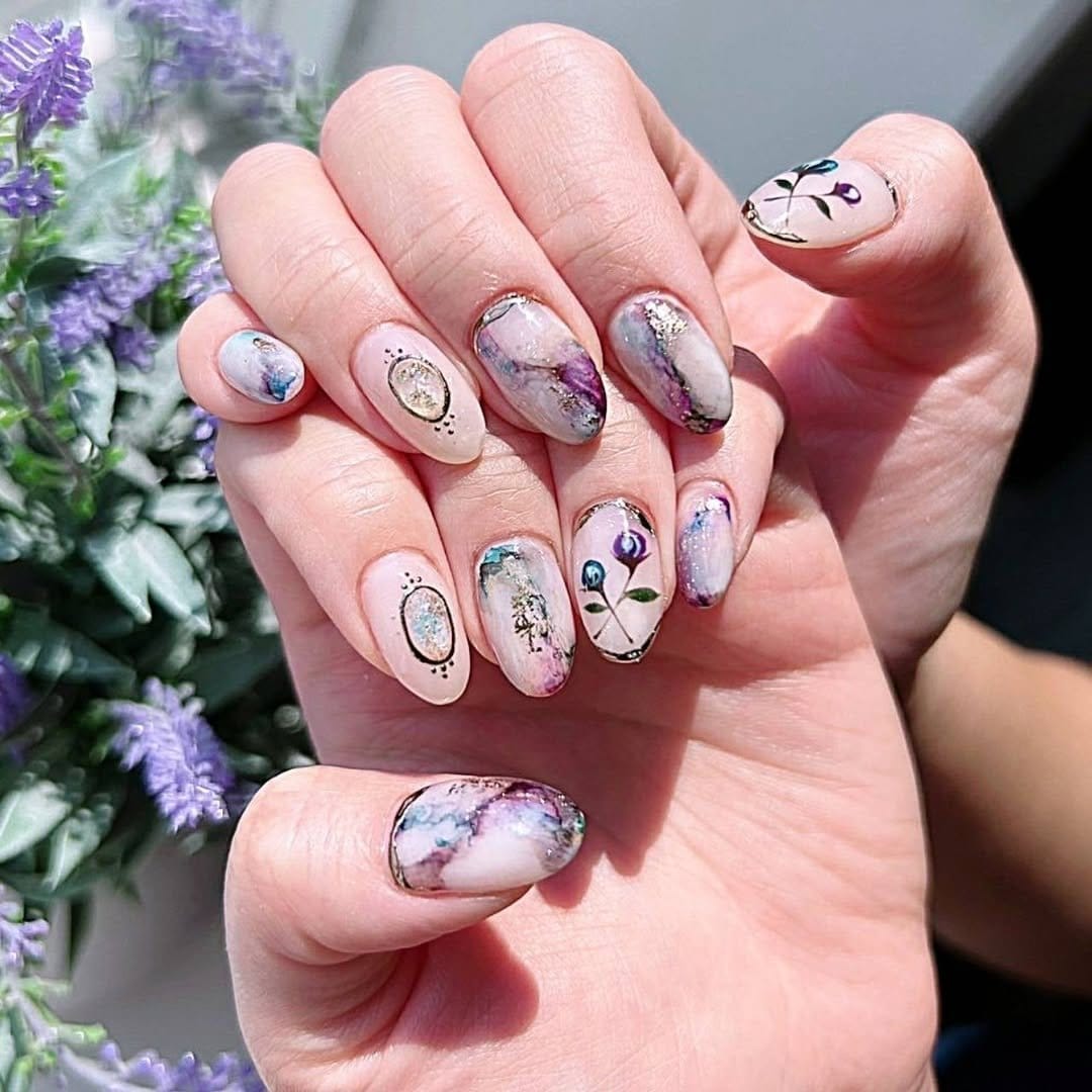 Watercolor-style floral nail art with soft pastels