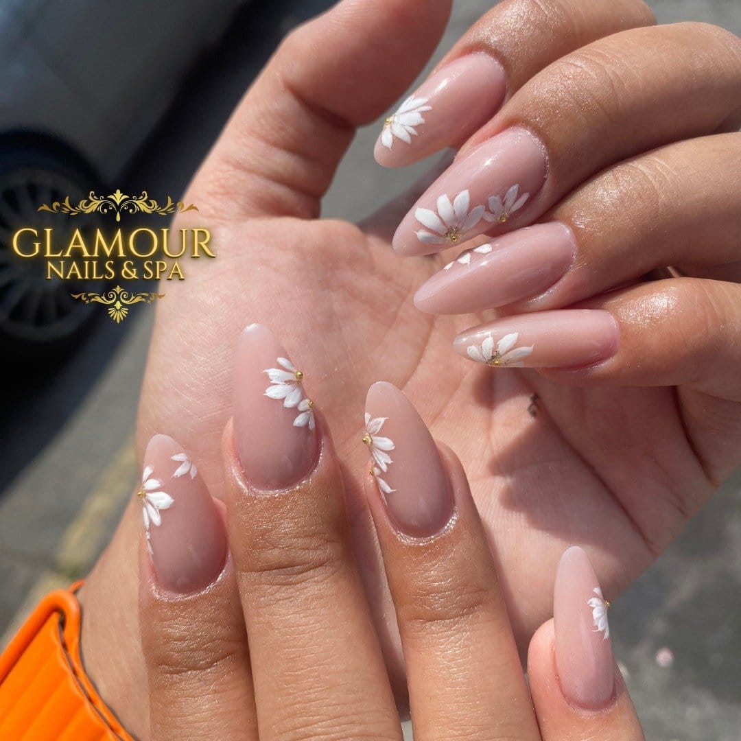 Nails with elegant pearl accents on a nude base