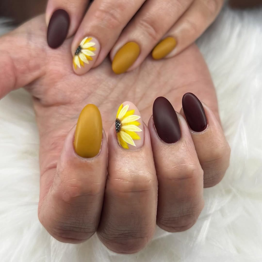 Pastel yellow nails with sunflower accents
