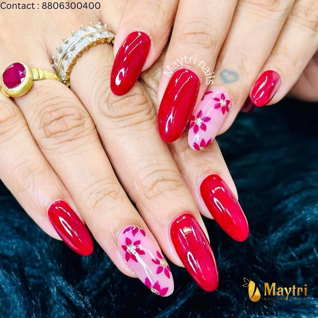 Delicate floral nail art on red nails