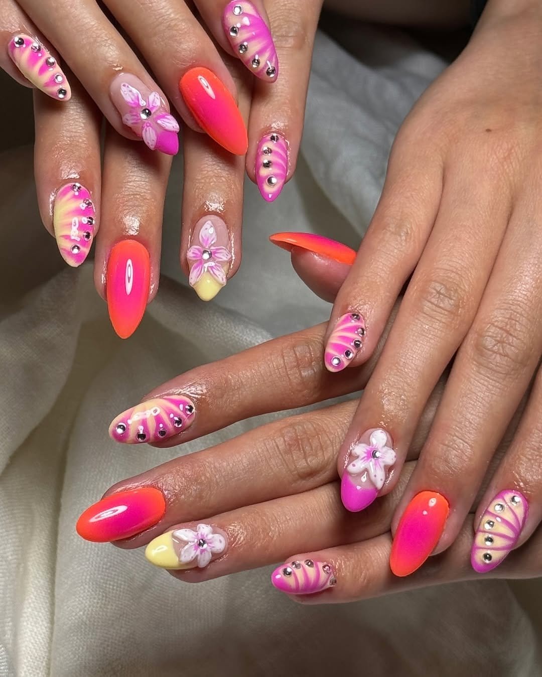 Bold pink and red tribal nail patterns